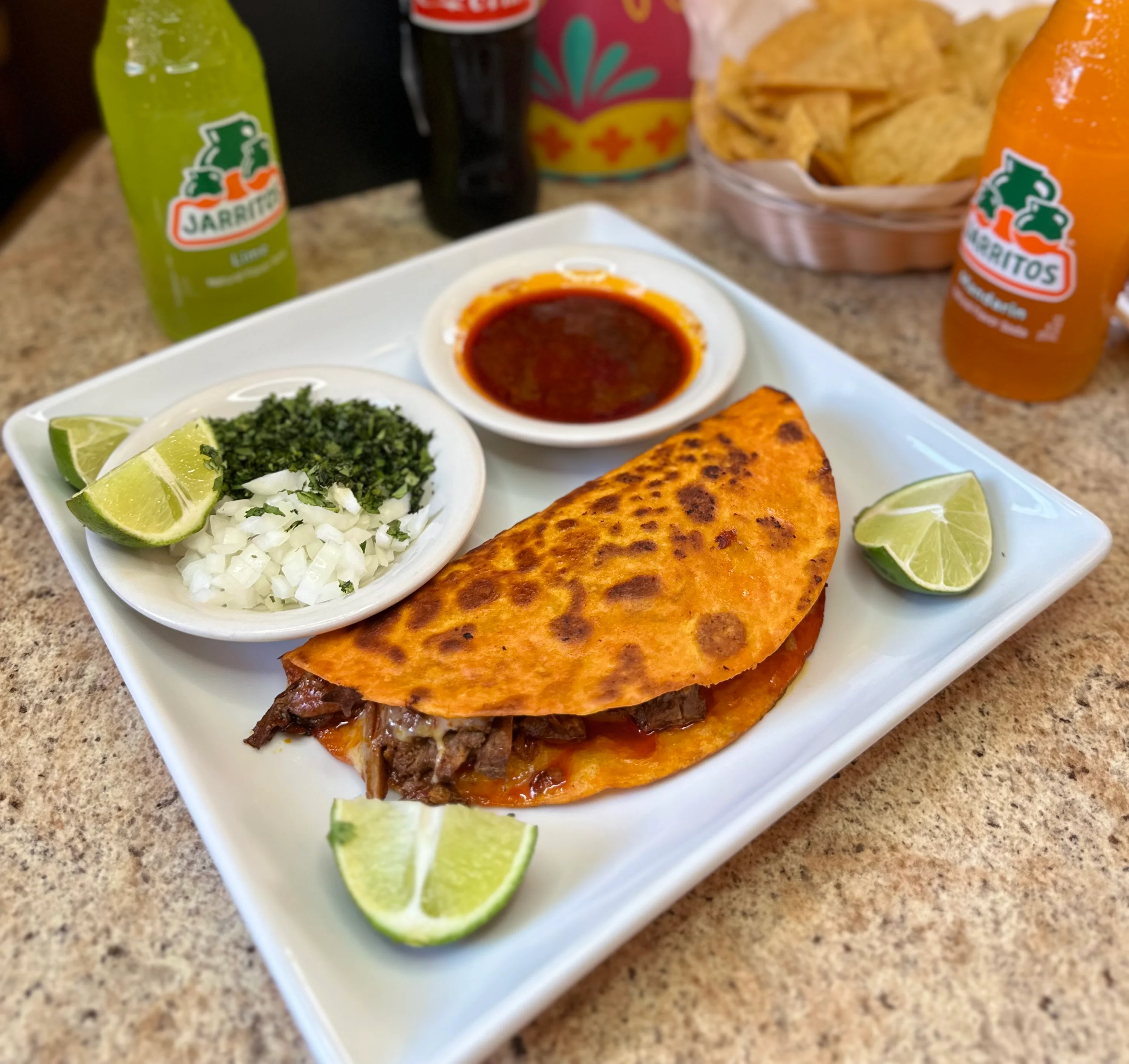Delicious Mexican taco with beef and lime wedges