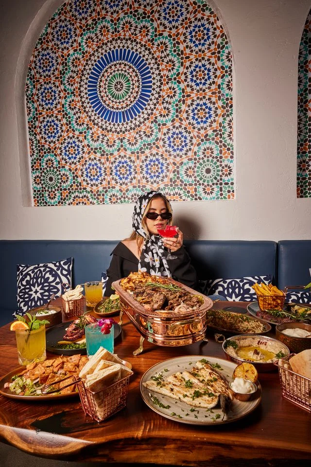 Women enjoying Mediterranean cuisines at Sufrat Grill.