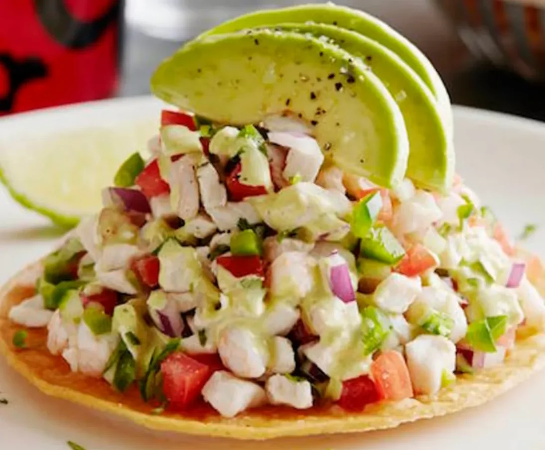 Fresh Mexican ceviche tostada with avocado slices
