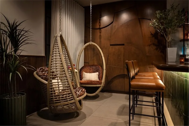 Stylish restaurant interior with hanging chairs and modern decor