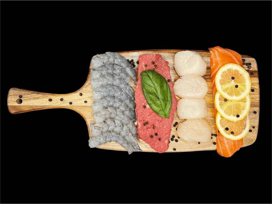 Raw shrimp, filet mignon, scallops and salmon on a board — hibachi proteins at Mahzu East Windsor