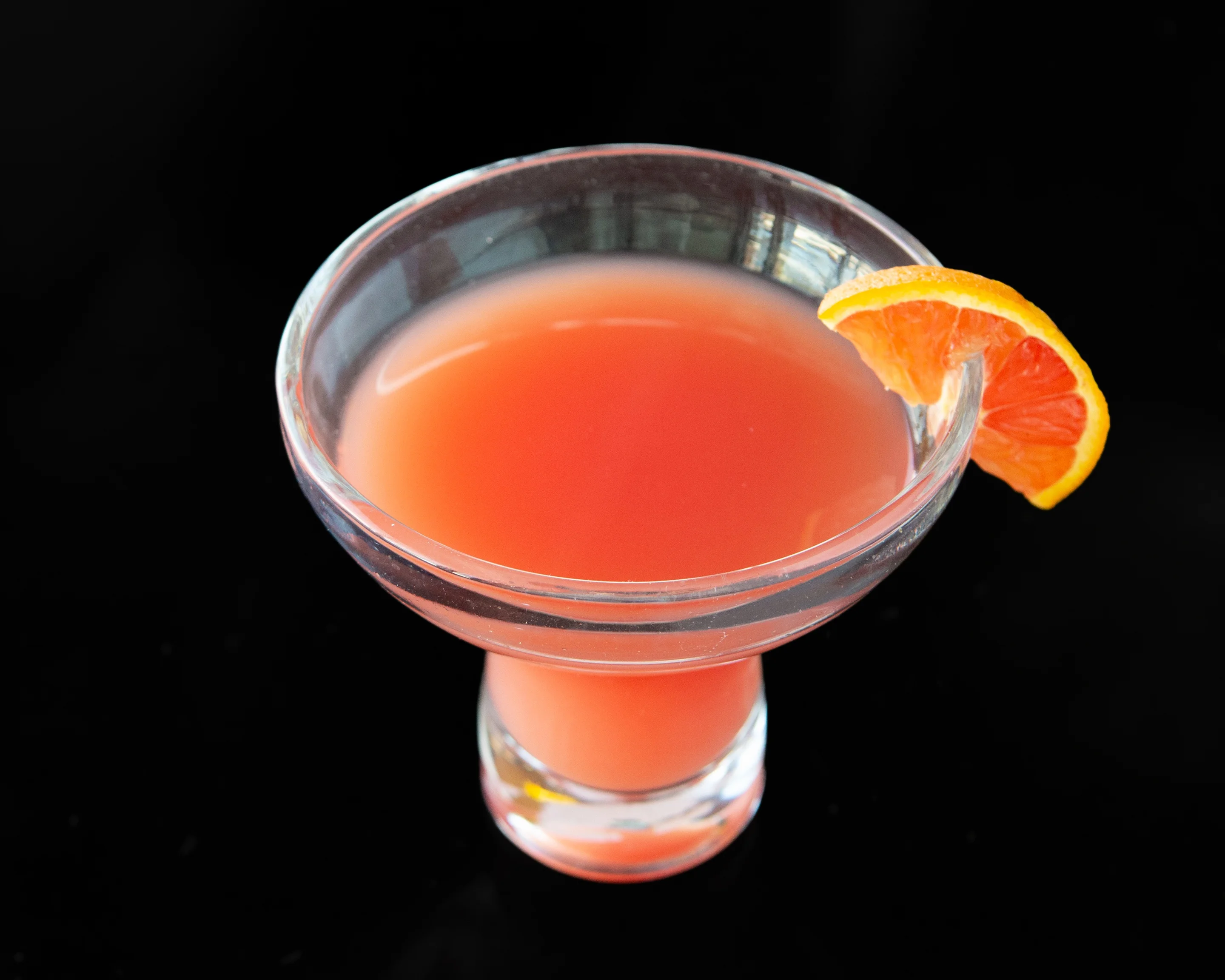 Refreshing cocktail garnished with a citrus slice