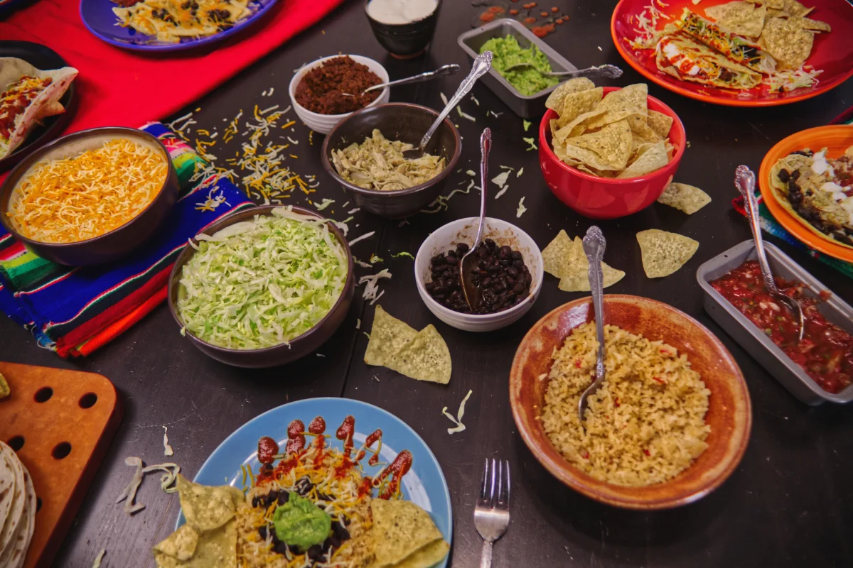 A vibrant spread of Mexican food with various toppings and sides.
