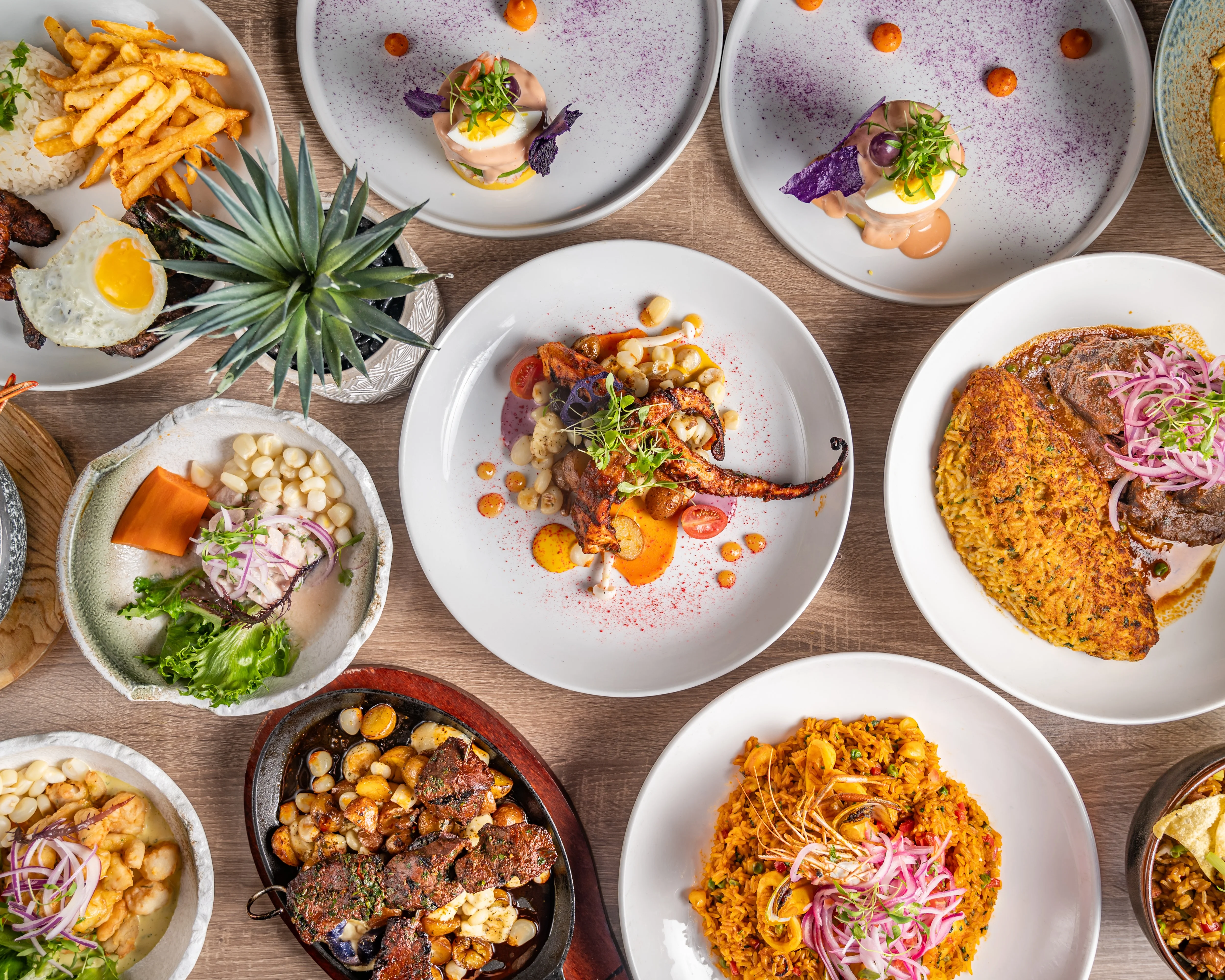 Colorful spread of Latin American dishes including octopus and rice