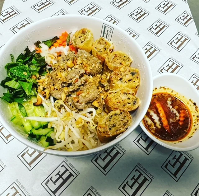 Vietnamese bun thit nuong with spring rolls and dipping sauce