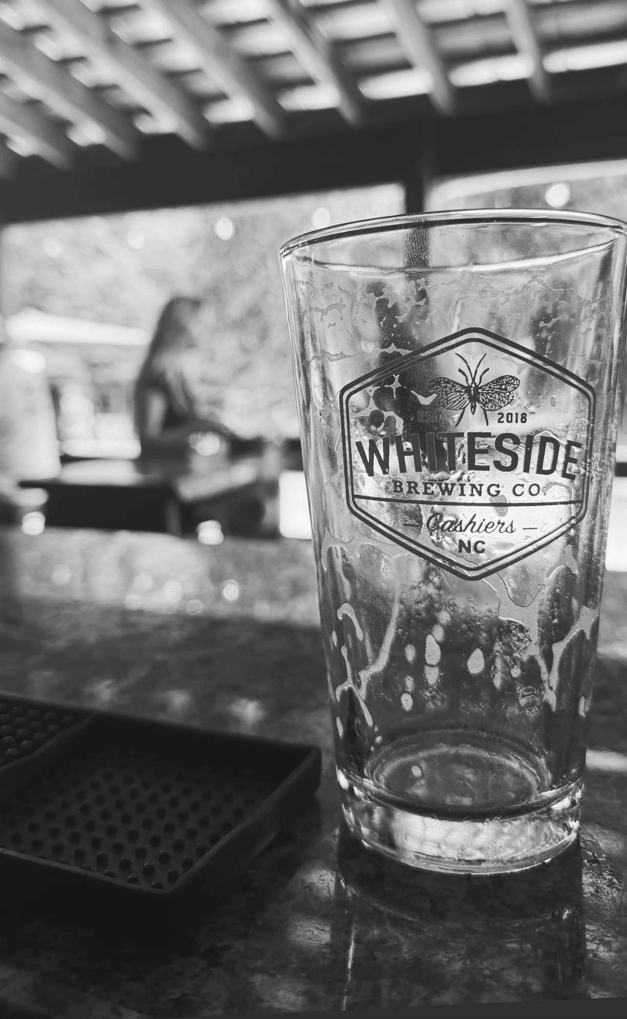 Outdoor brewery with picnic tables and umbrellas