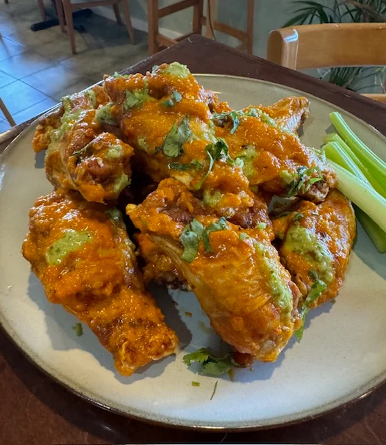 Crispy buffalo chicken wings with green sauce