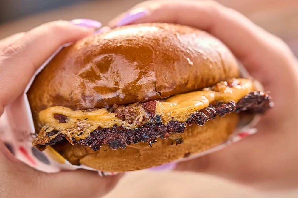Juicy cheeseburger with melted cheese on a brioche bun