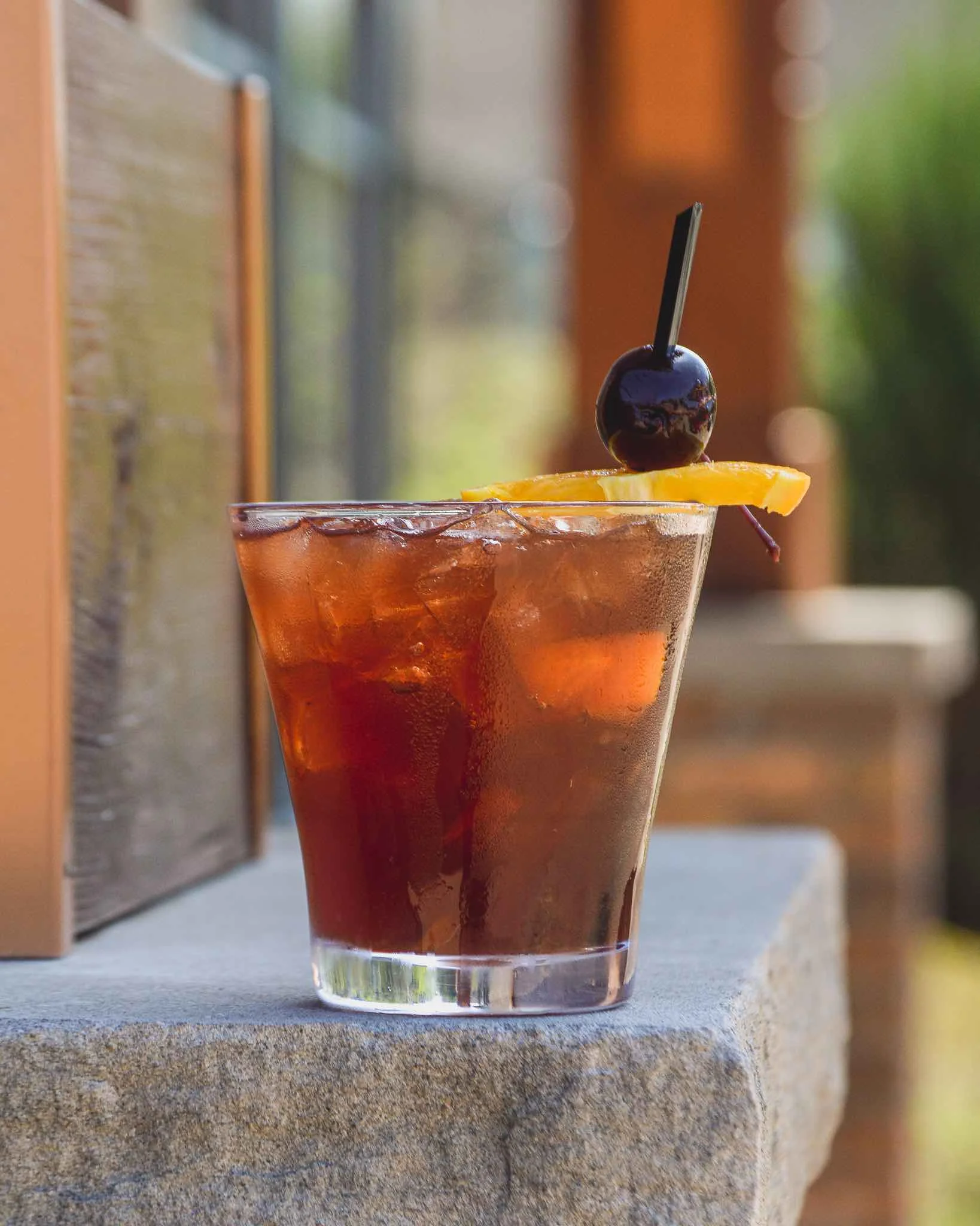 Rye Not An Old Fashioned cocktail outside on a table with the sun shining