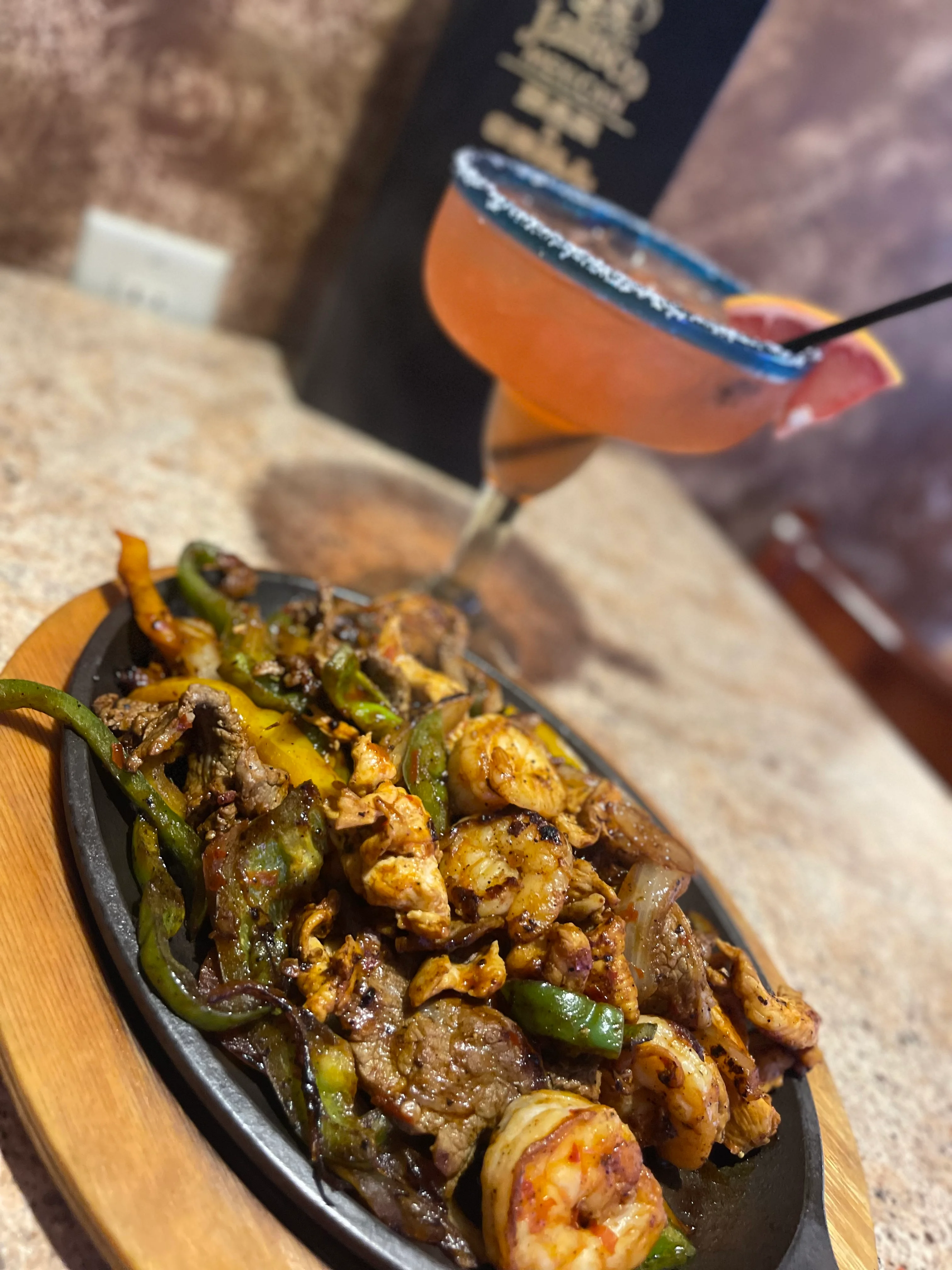 Sizzling fajitas with shrimp and beef served in a restaurant