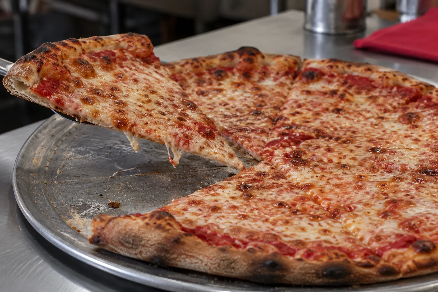 New York-style cheese slice lifted from a freshly baked pizza