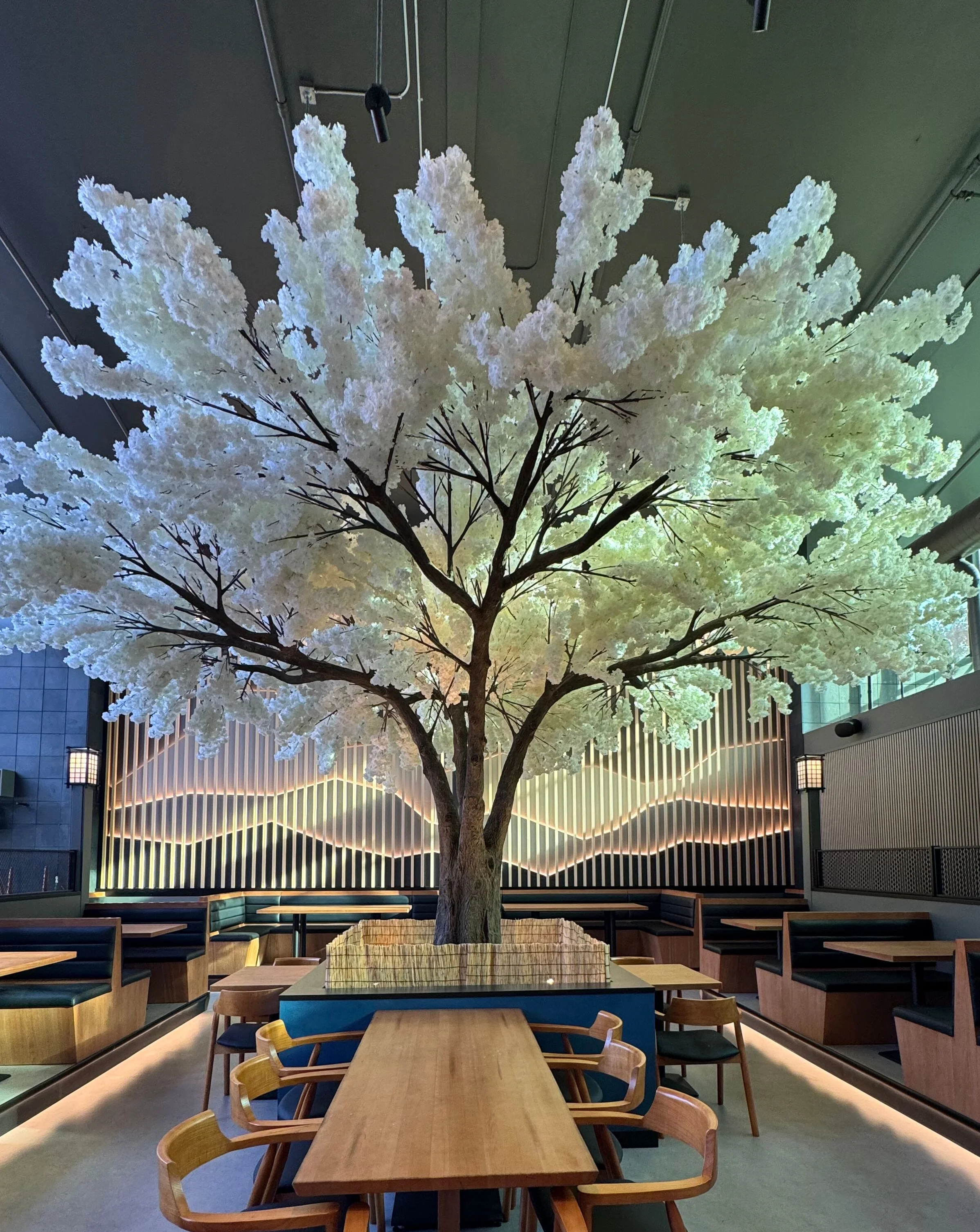 Stylish restaurant interior with a large decorative tree