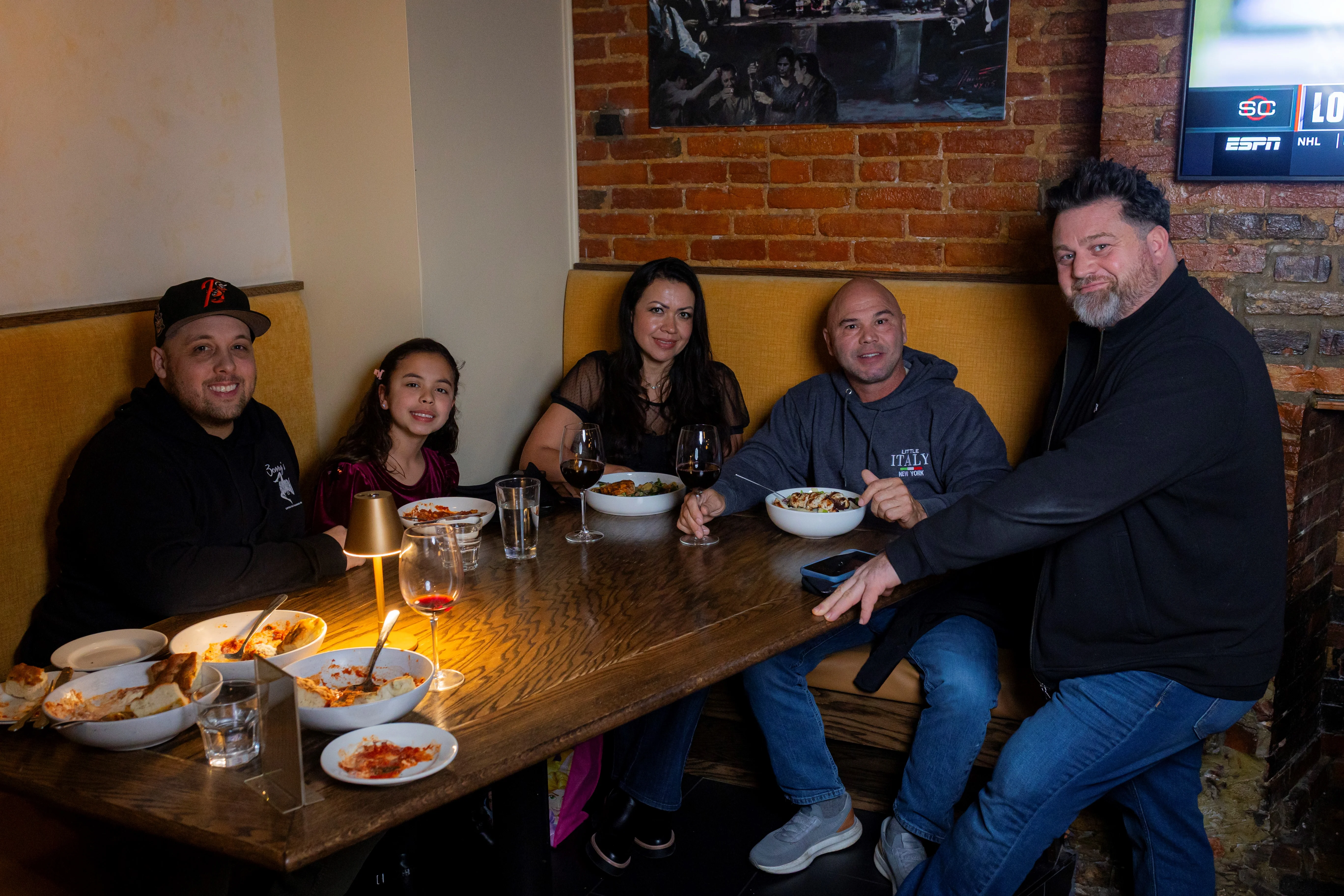 Family enjoying Italian pasta dishes in a cozy restaurant setting