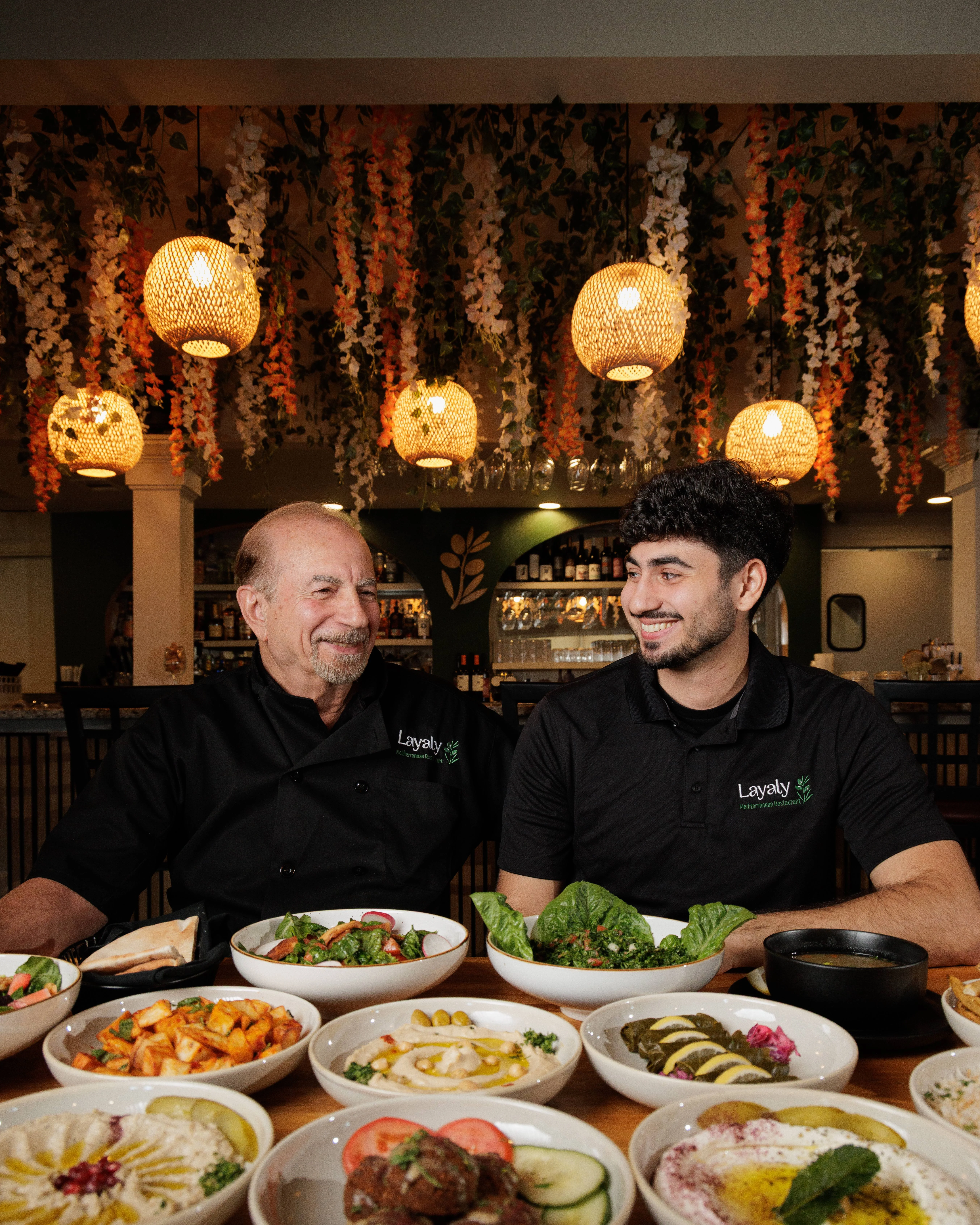 Group photo of diners enjoying a meal at a restaurant table.