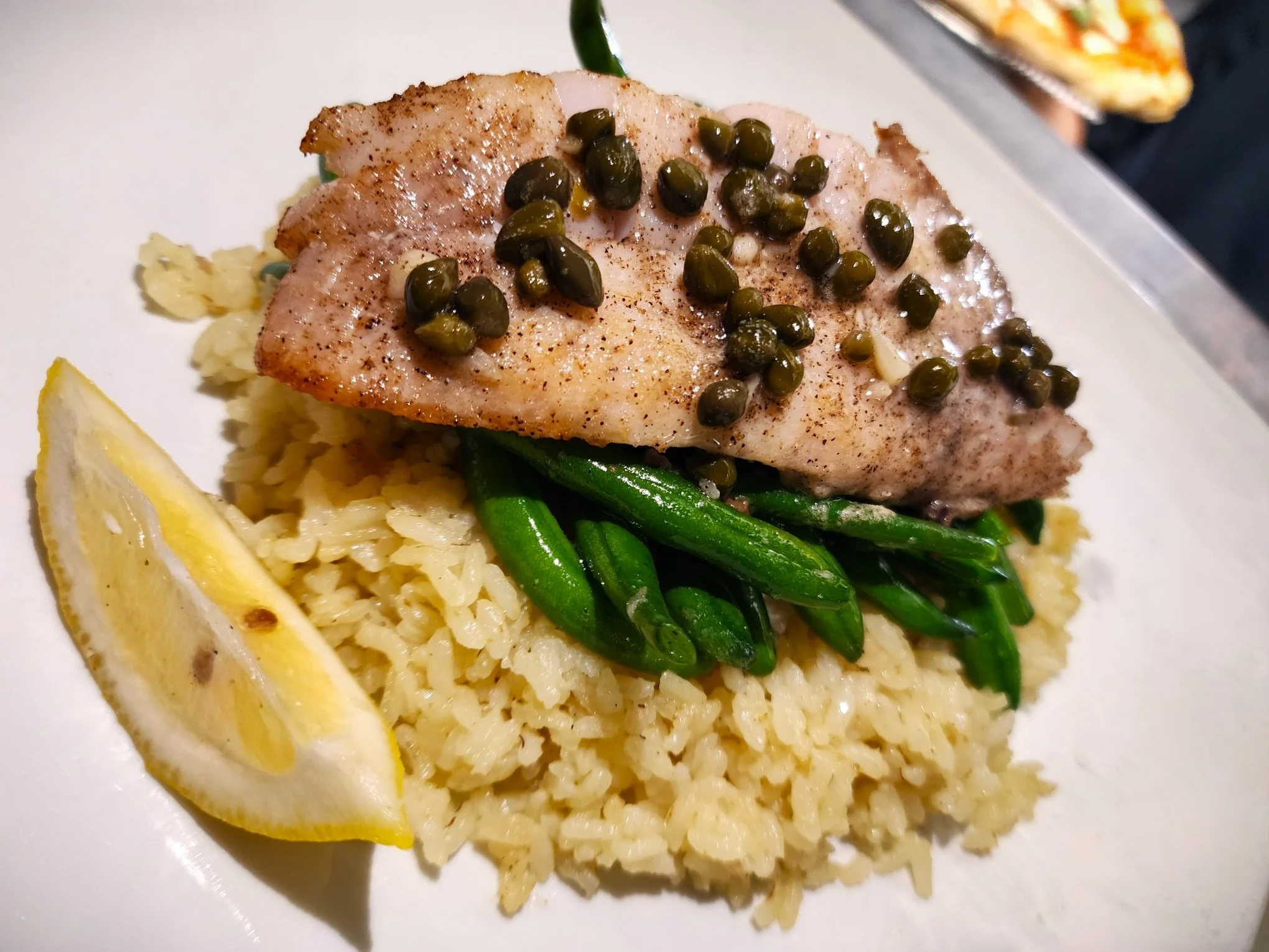 Pan-seared fish with capers on herbed rice