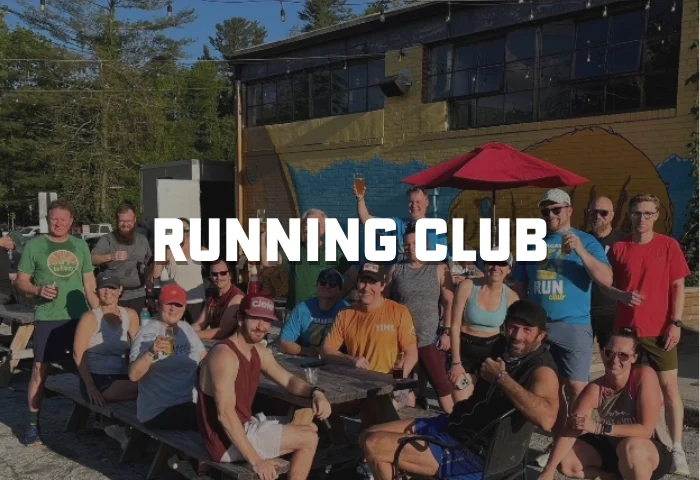 Group of runners enjoying drinks after a club run