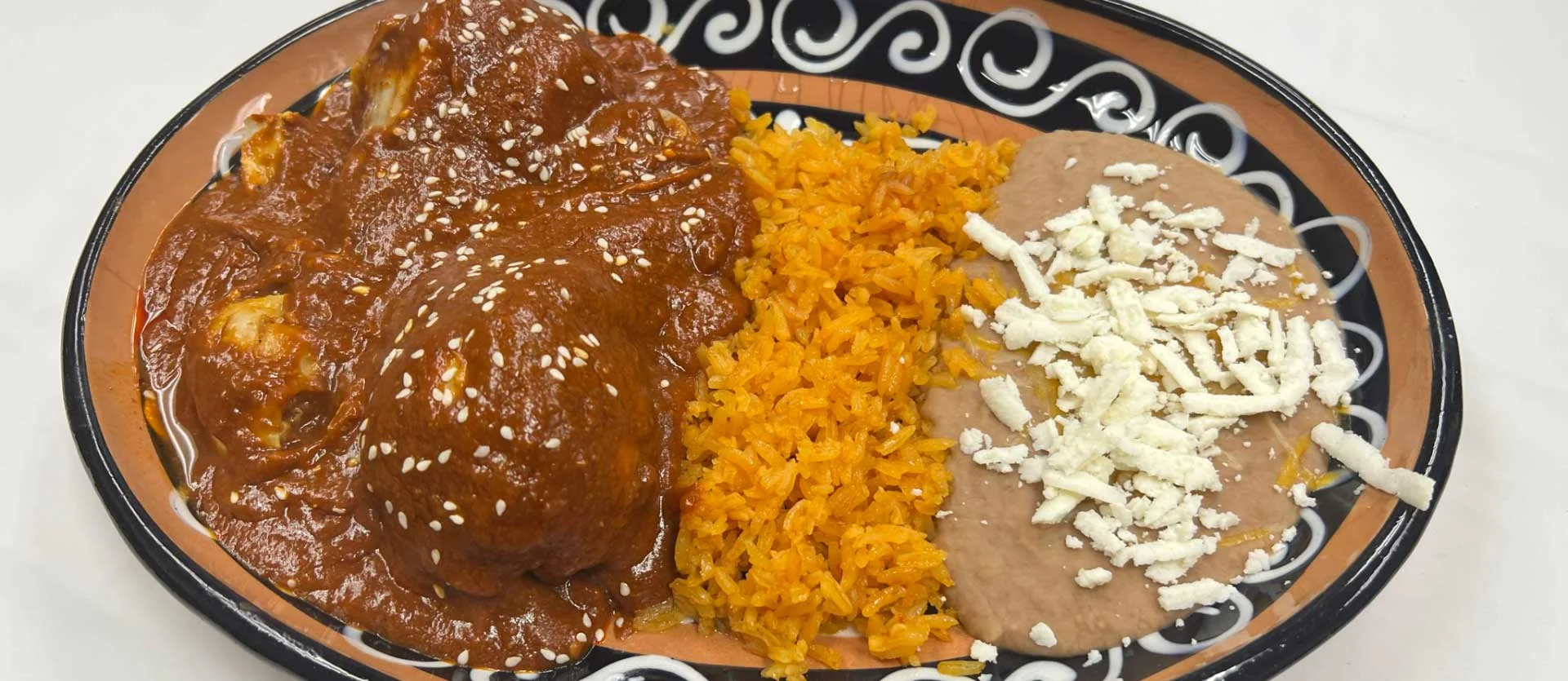 Authentic Mexican mole with rice and refried beans