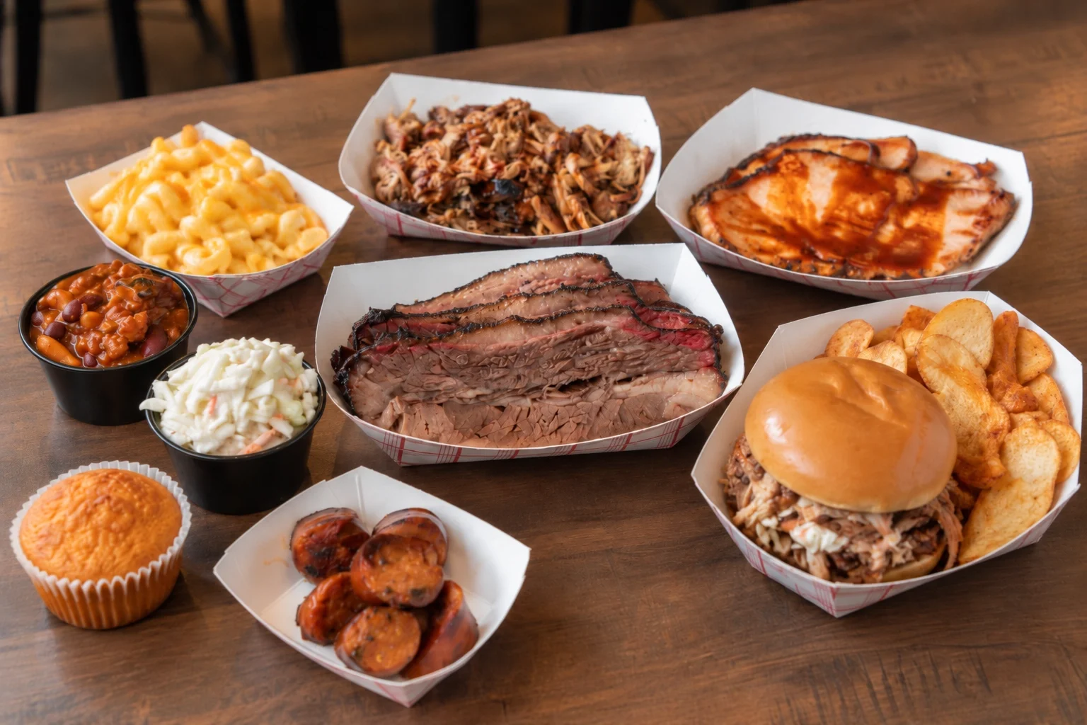 Assorted barbecue platter featuring brisket, pulled pork, and sides