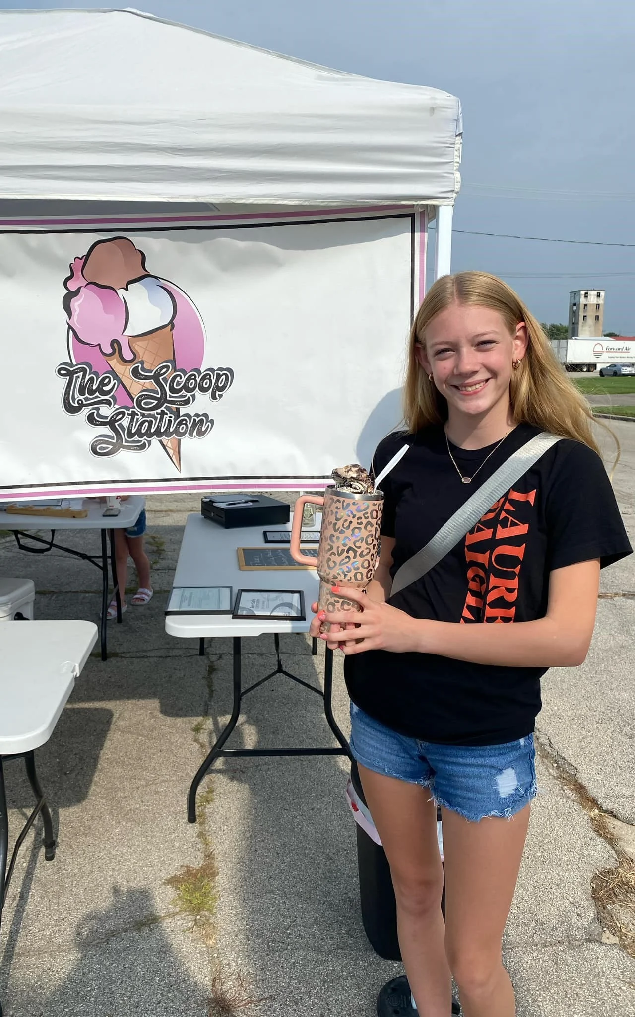 Girl holding a colorful ice cream drink at The Scoop Station