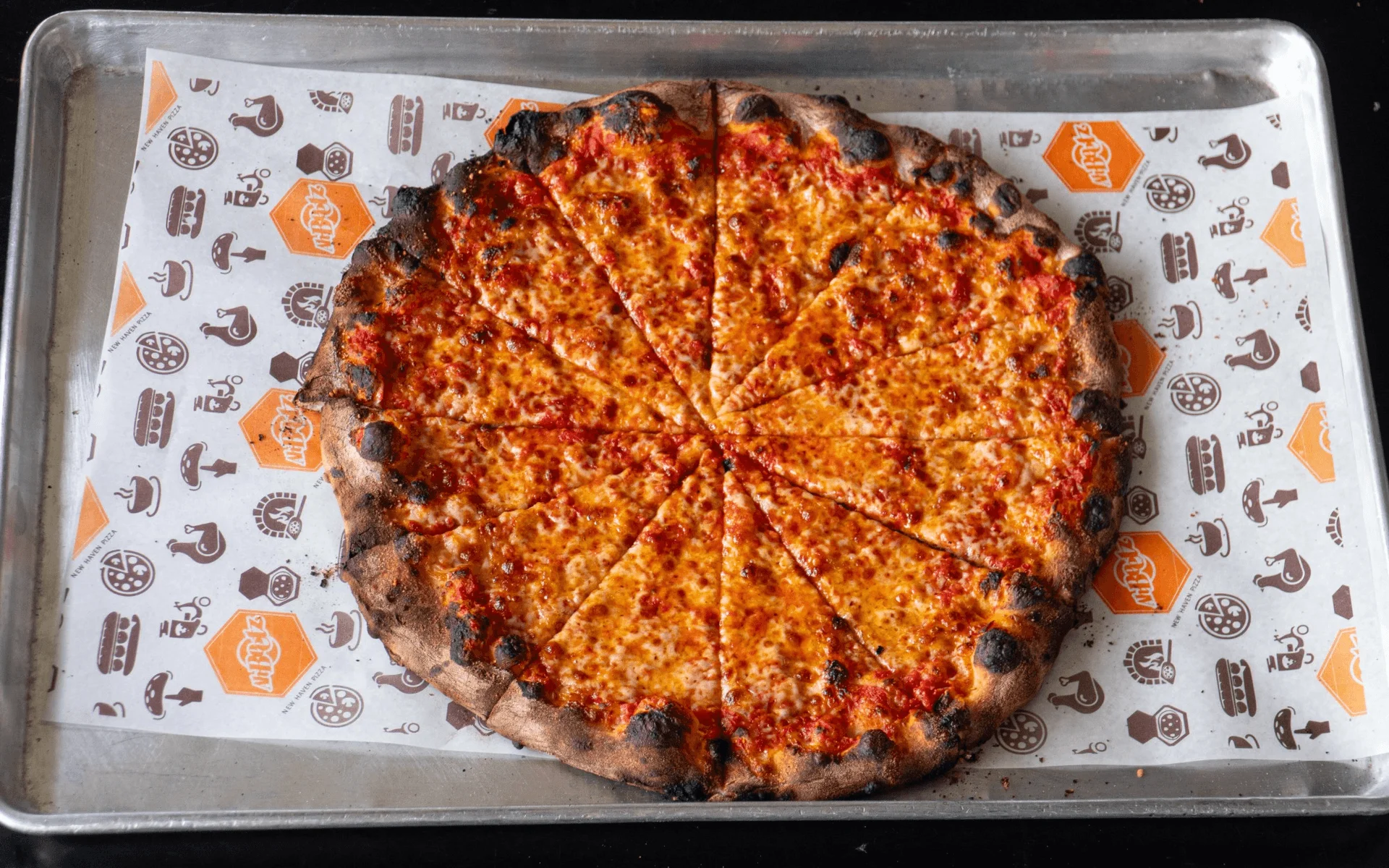 Classic cheese pizza on a metal tray