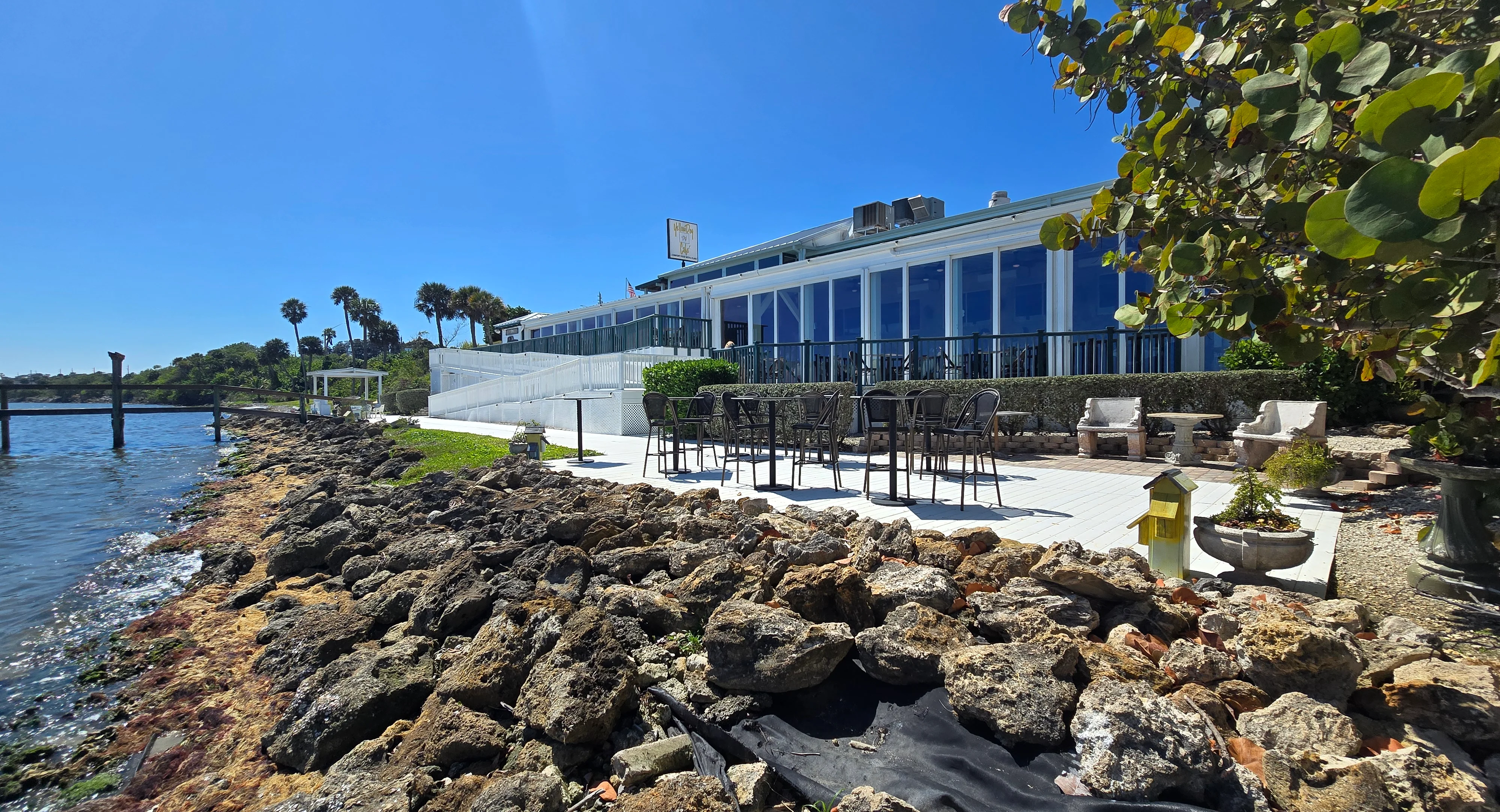 Scenic waterfront view of Yellow Dog Cafe with outdoor seating