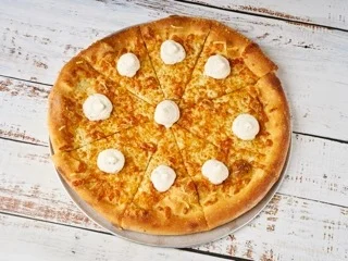 A cheese pizza adorned with dollops of a creamy topping, arranged evenly across the surface, and cut into slices.