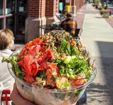 Colorful poke bowl with fresh vegetables and toppings
