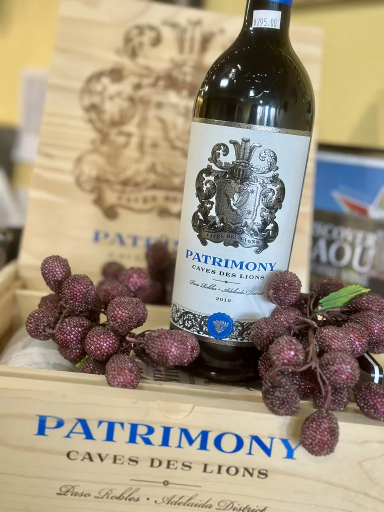 Bottle of Patrimony wine with decorative box and berries