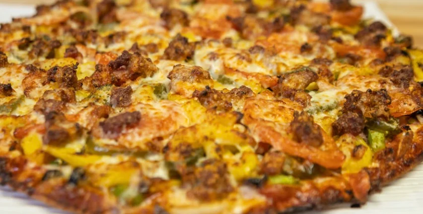Loaded meat lover's pizza with cheese and vegetables