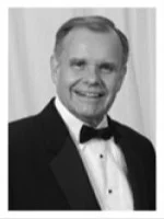 Smiling man in a tuxedo at a formal event