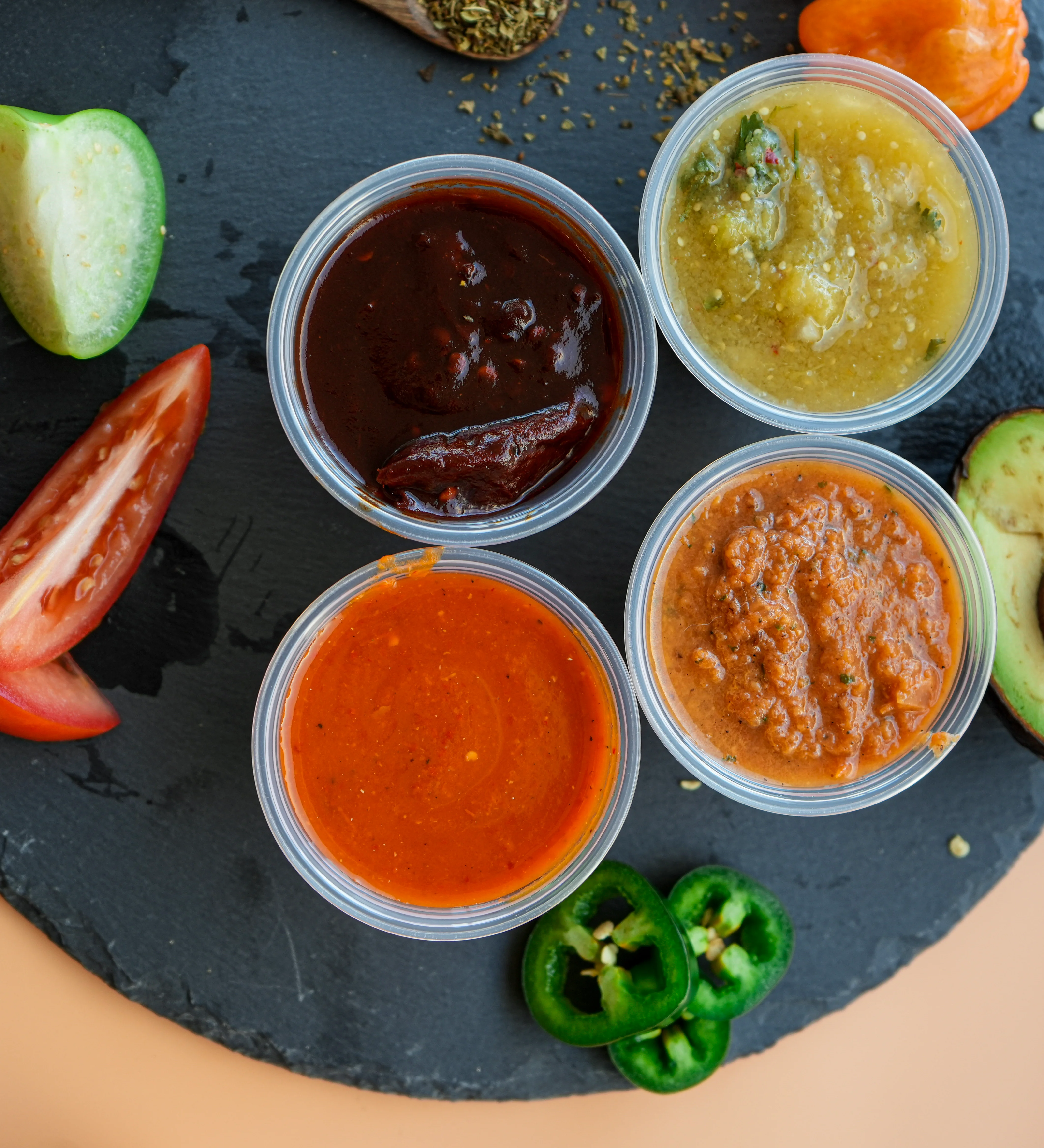 Variety of vibrant salsas served in cups, showcasing Mexican cuisine