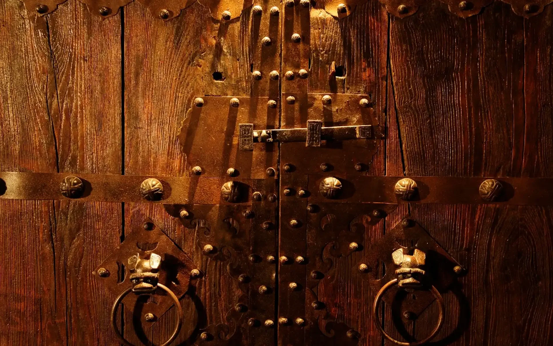 Intricately designed wooden door with metal accents and hardware