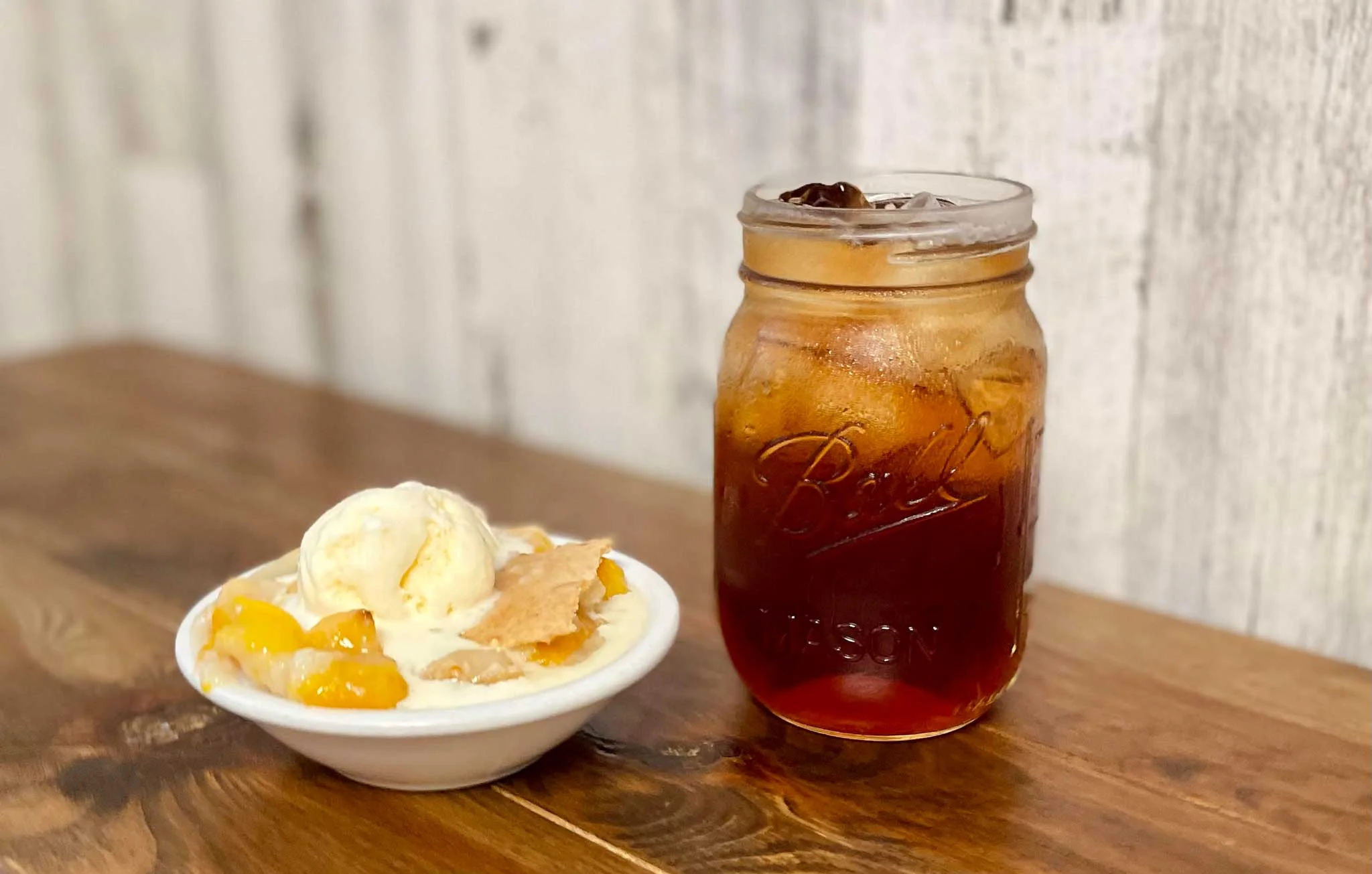 Peach cobbler dessert with vanilla ice cream