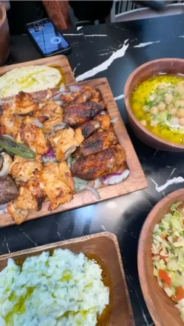 Middle Eastern mixed grill platter with hummus and salad