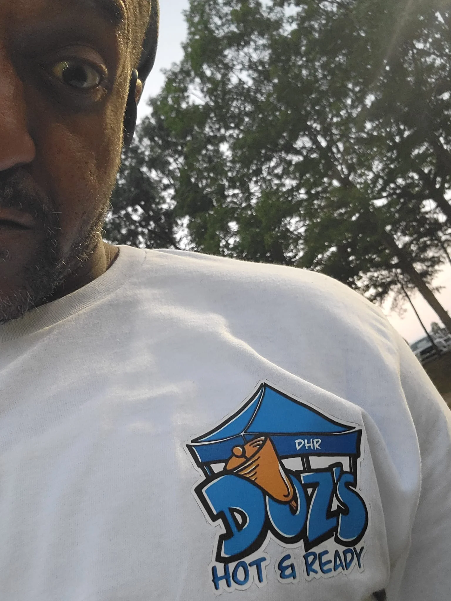 Doz DHR merchandies on a blank white tee.