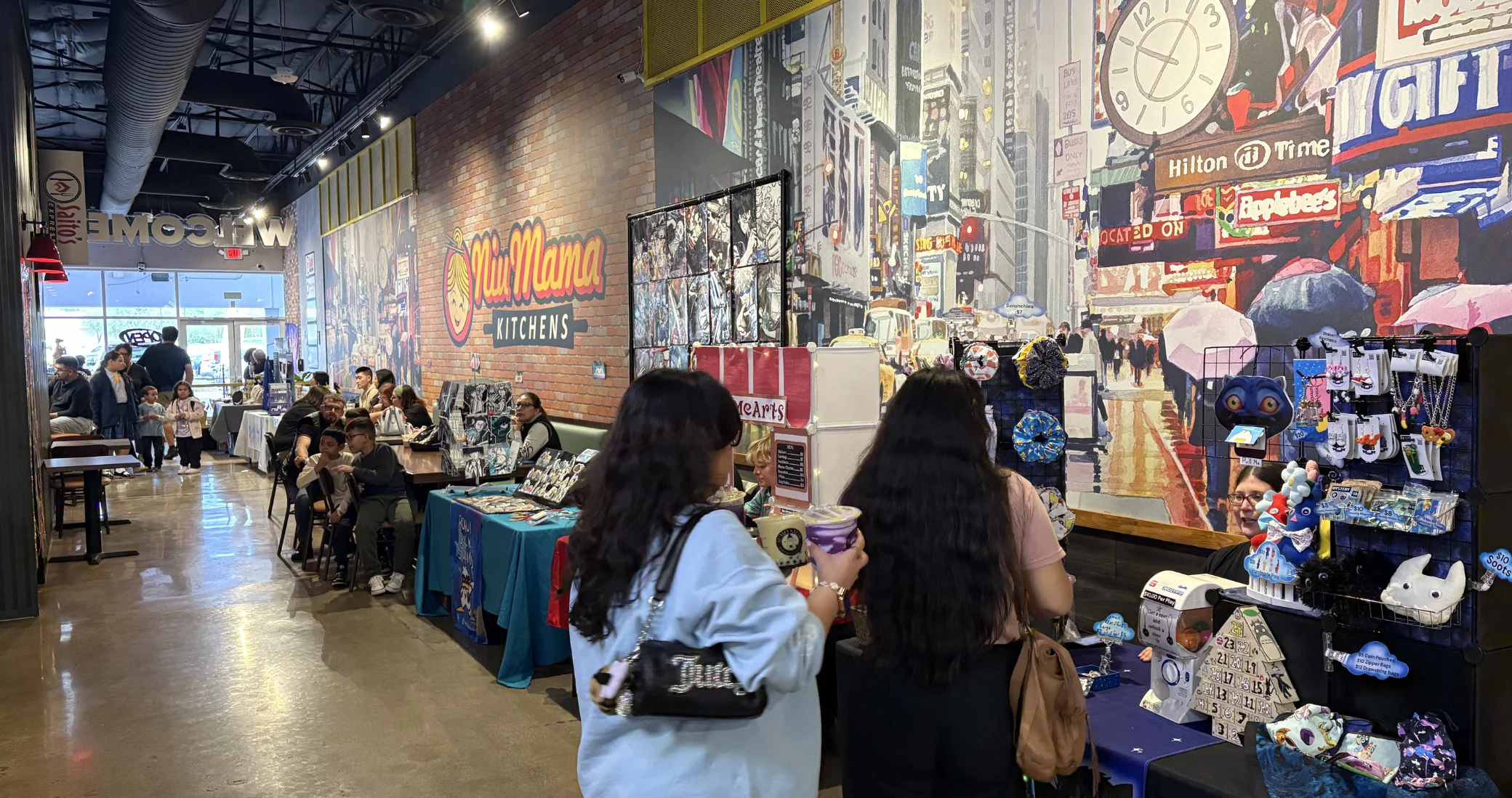 Interior of a restaurant with vendors and customers enjoying the space.