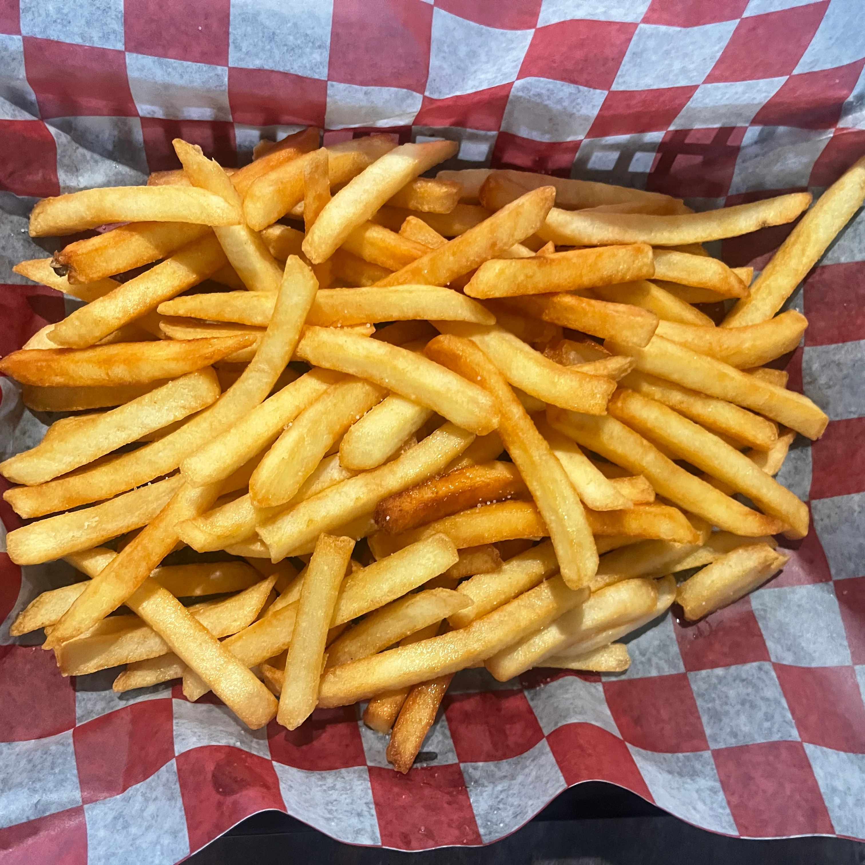 Crispy French fries served in a checkered basket