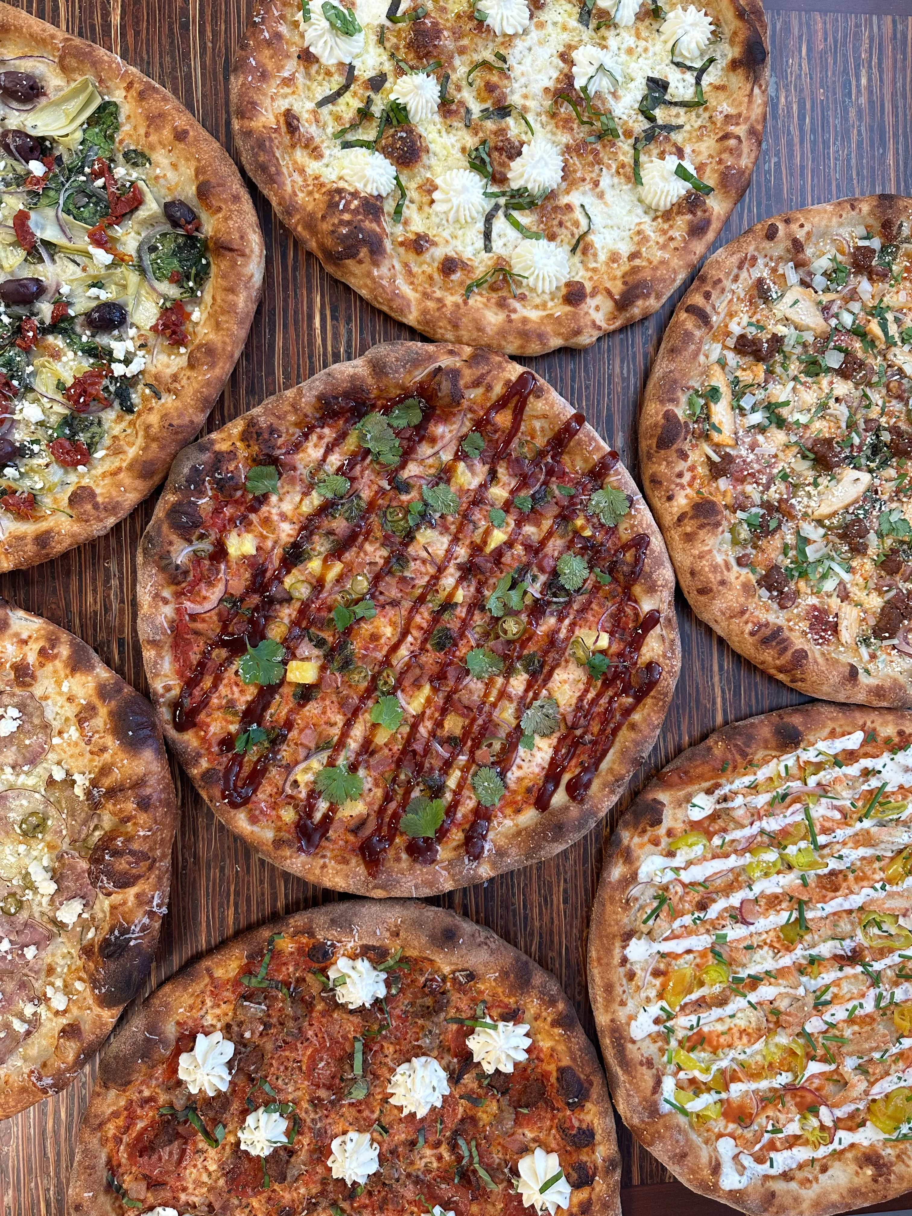Artisan pizzas featuring diverse toppings and styles