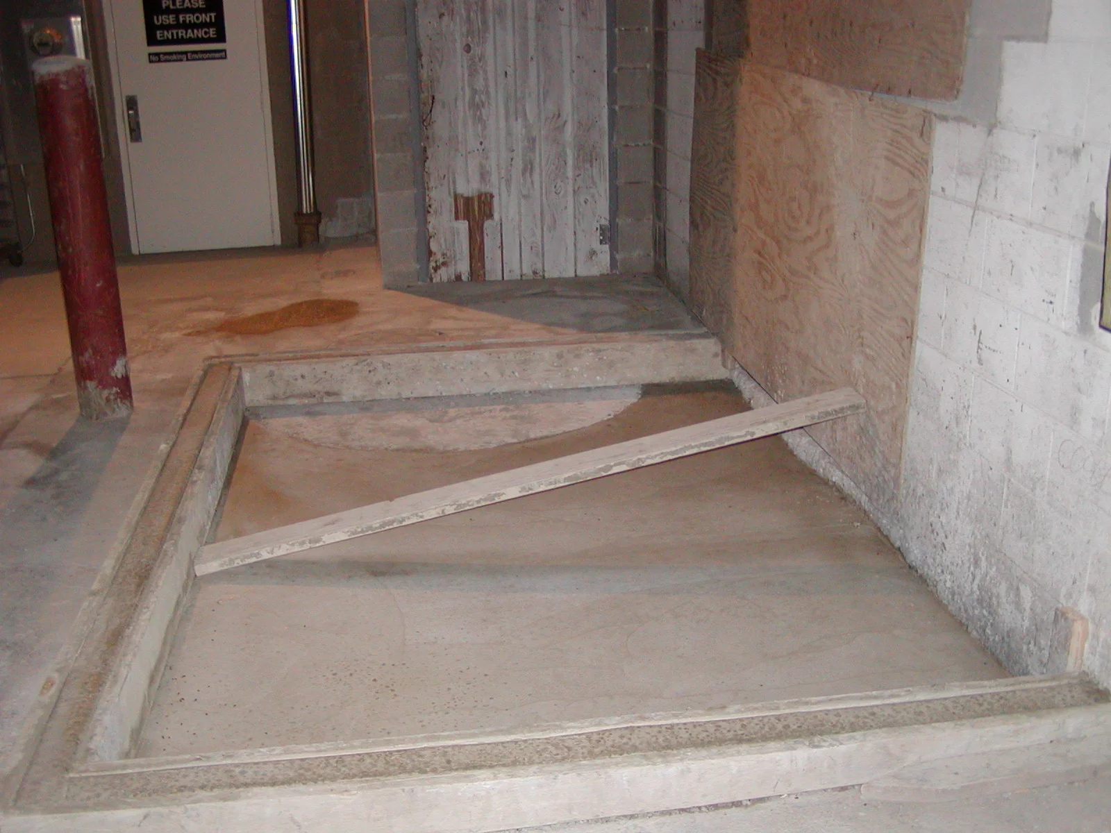 Empty concrete area with wooden support beam in a construction site