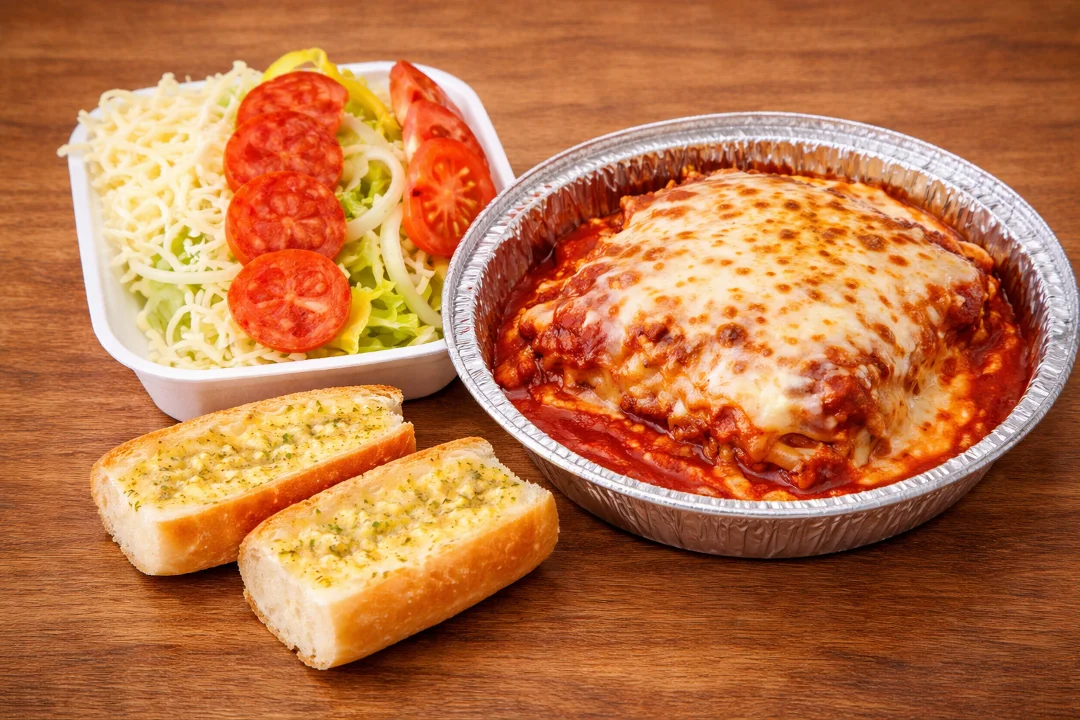 A pizza topped with slices of tomato, yellow peppers, and onions on a crispy crust. The vibrant colors of the vegetables add freshness to the dish.