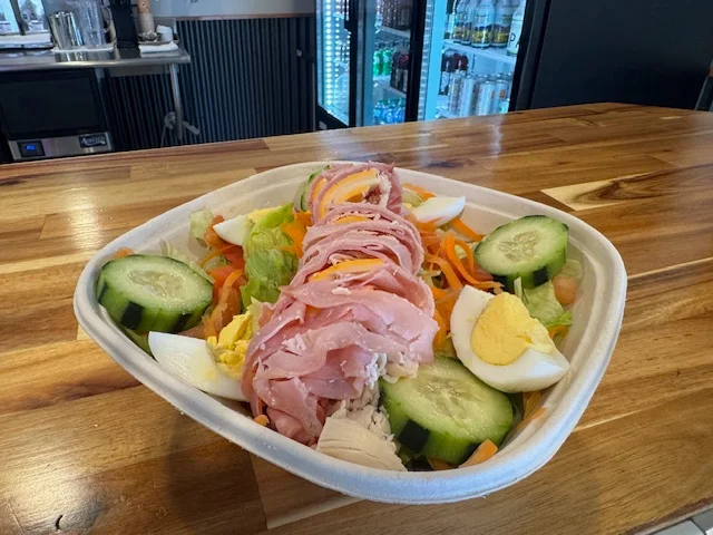 A colorful chef salad with various fresh vegetables and toppings.