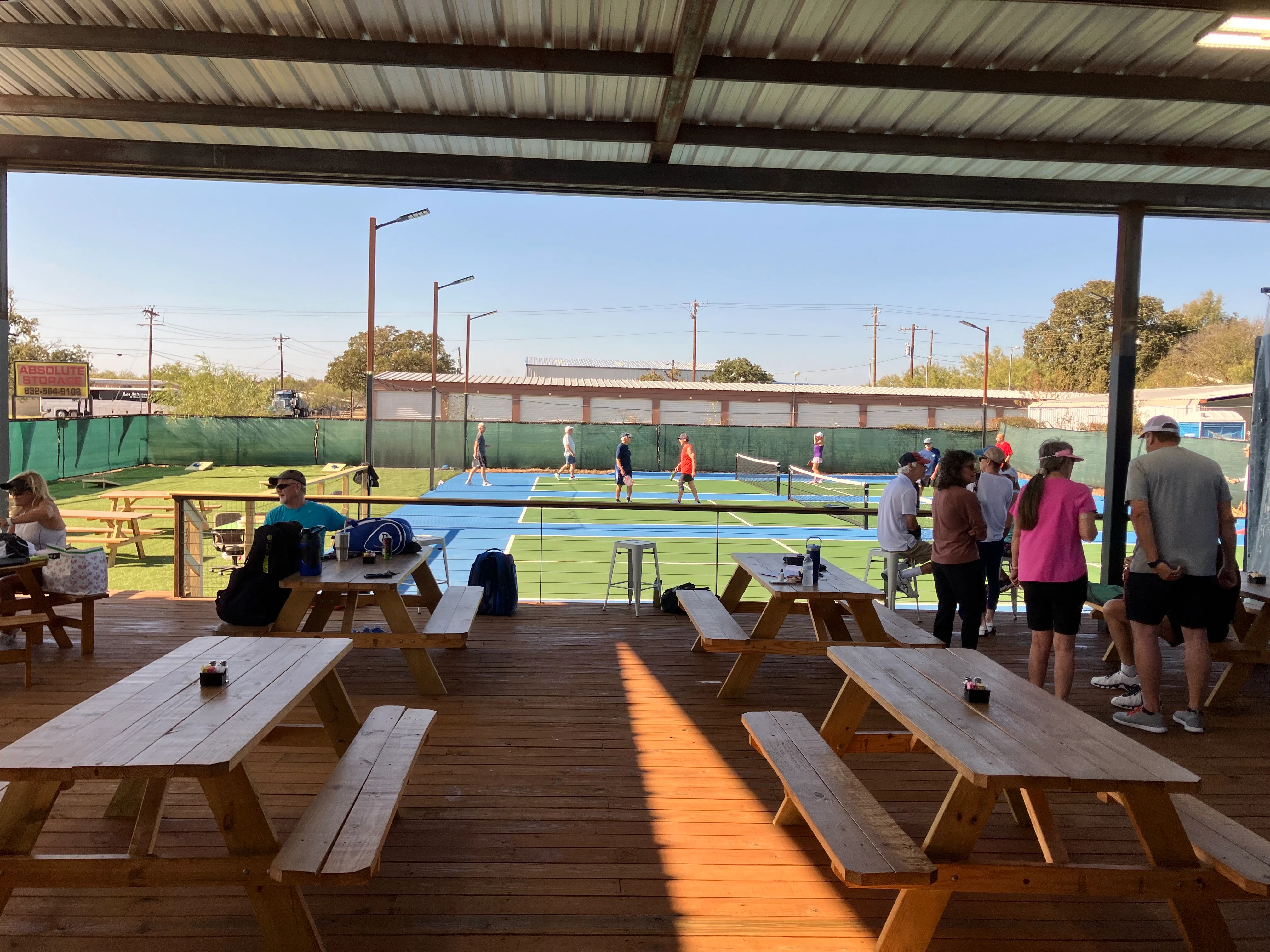 Outdoor dining area overlooking tennis courts