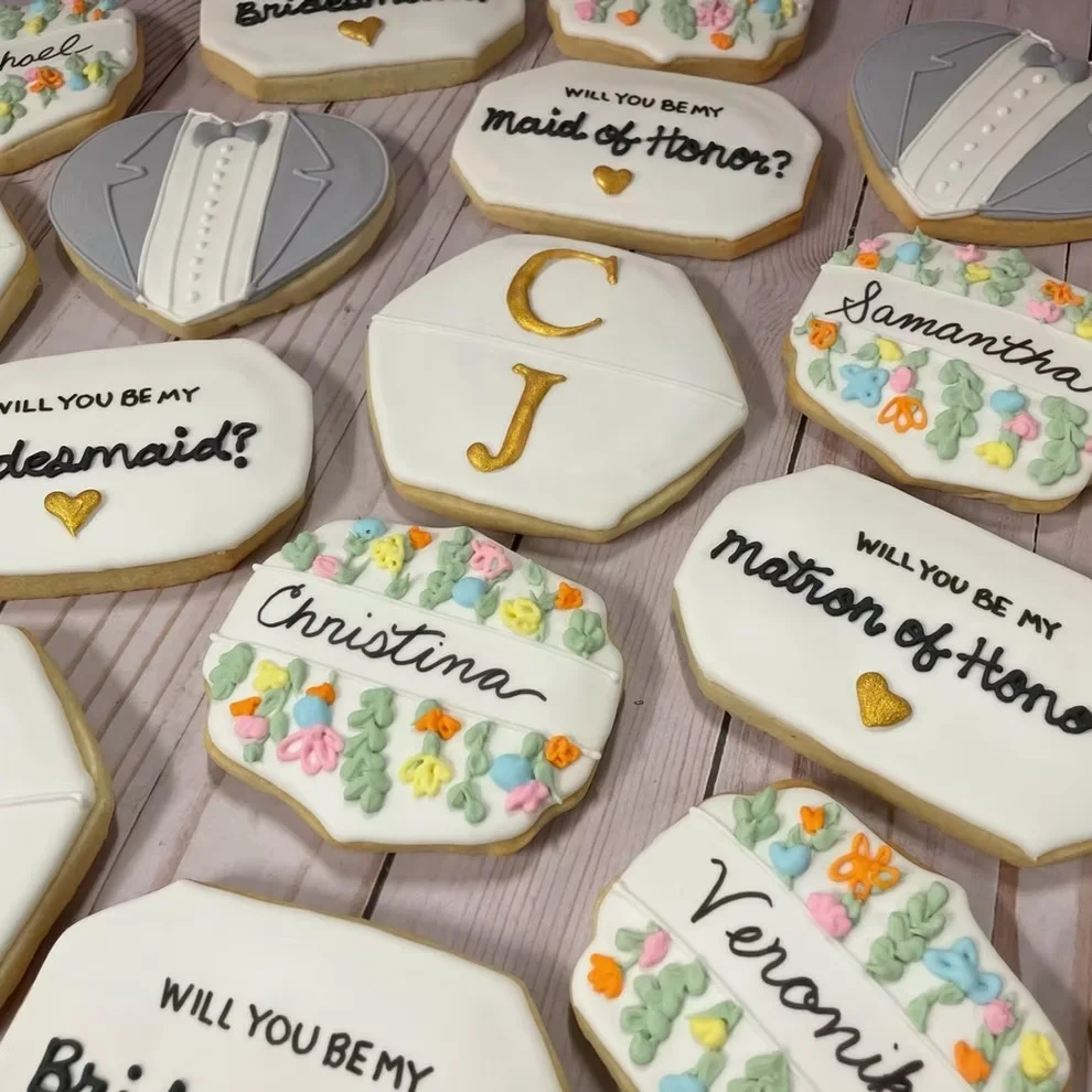 Decorative cookies featuring floral and baby-themed designs