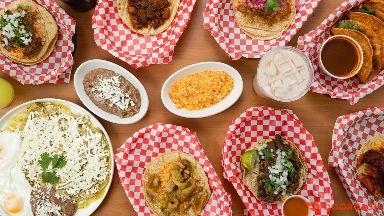 Assorted Mexican tacos with sides of rice and beans