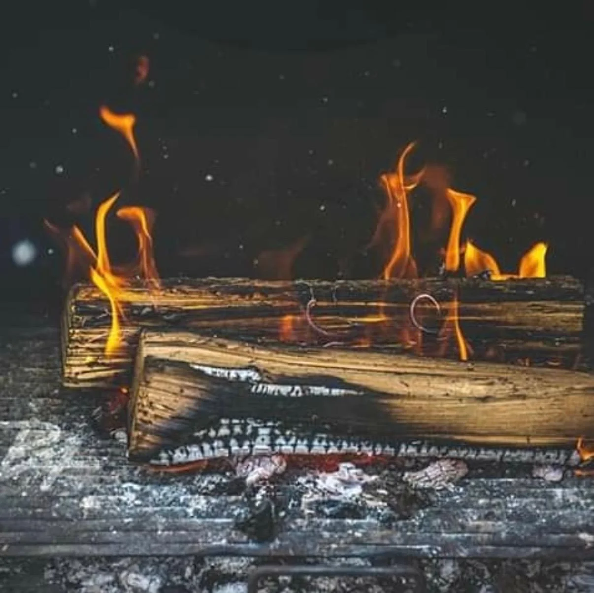 Burning logs in a cozy fireplace setting