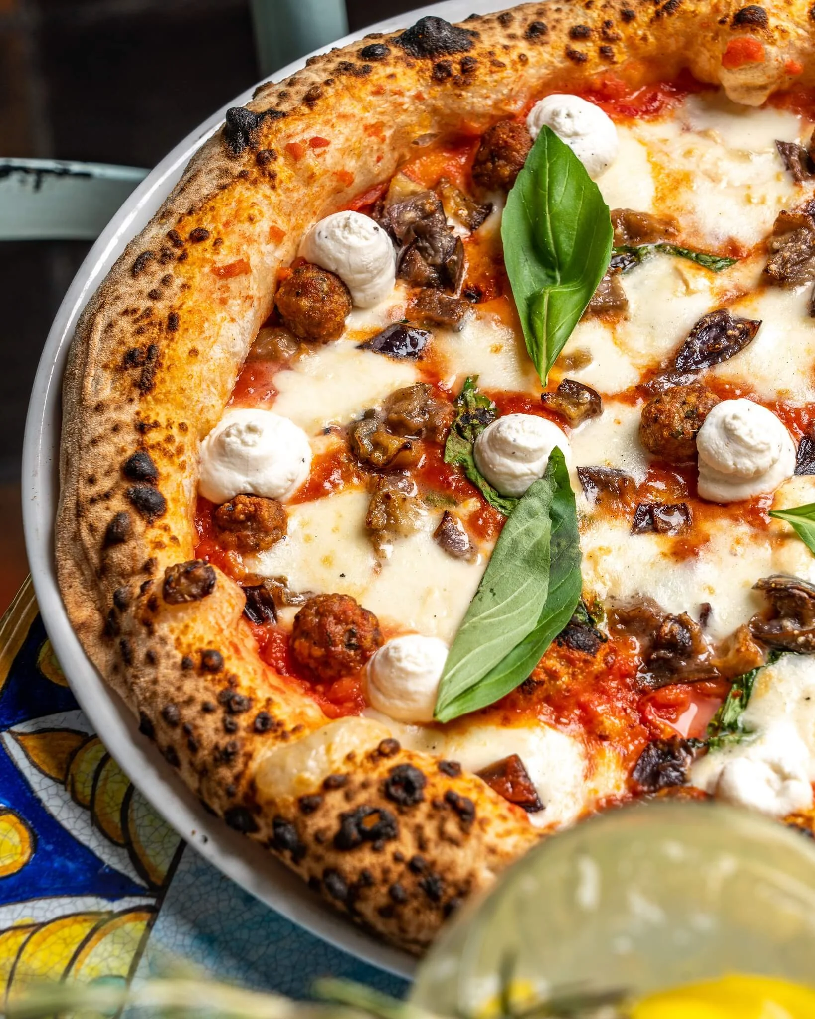 A variety of delicious pizzas displayed in a vibrant restaurant setting.