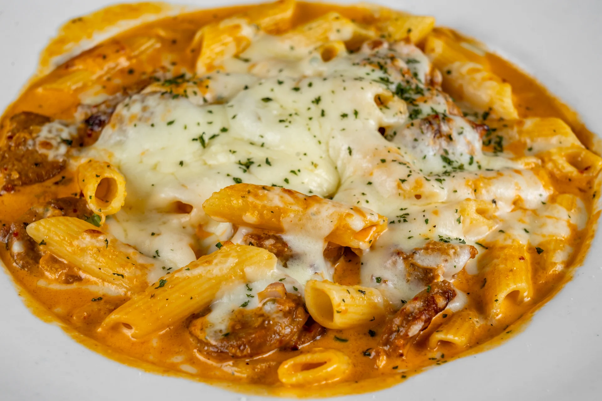 Creamy baked ziti with melted cheese and herbs