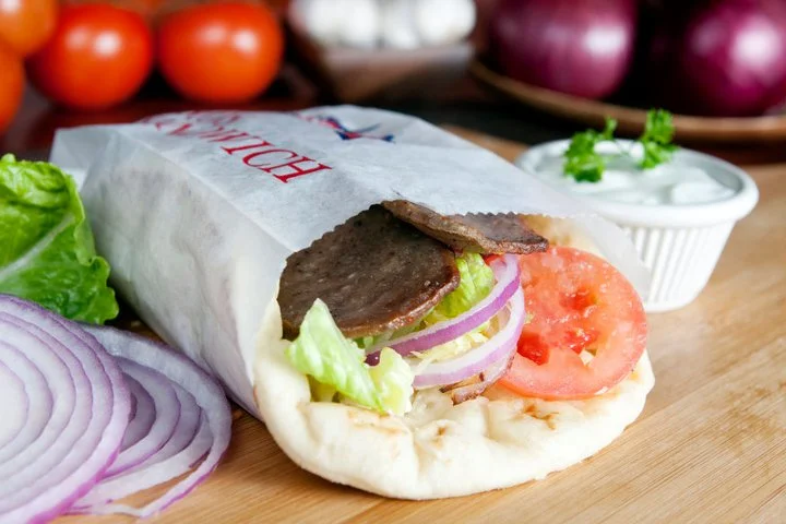 Delicious sandwich with fresh ingredients on a wooden table.