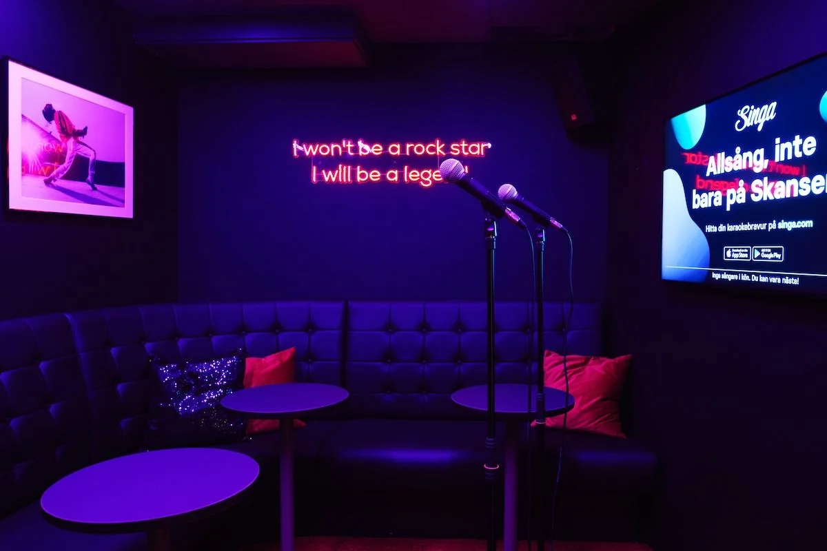 Karaoke room with neon lights and microphones