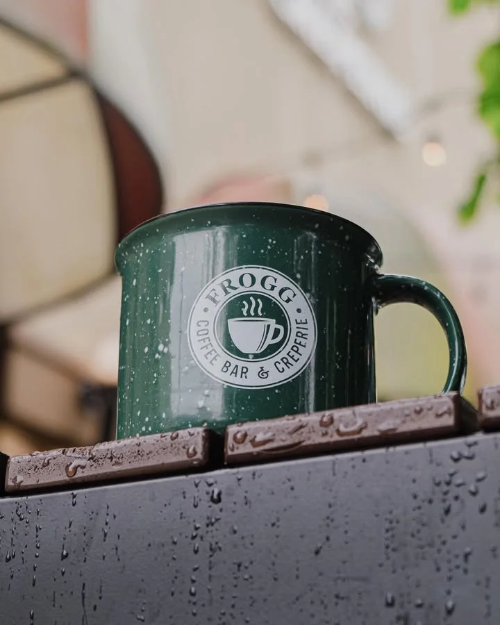Green coffee mug from Frogg Coffee Bar & Crêperie with raindrops